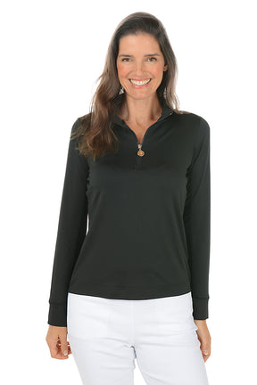 Woman wearing a black long-sleeve top and white pants on a white background. Second front shot.