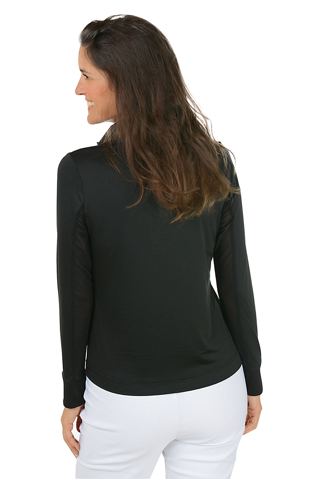 Woman wearing a black long-sleeve top and white pants on a white background. Back shot.