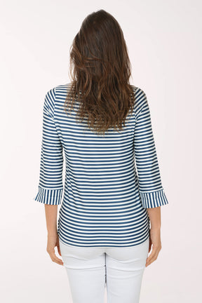 Woman wearing a 3/4 sleeve striped navy and white top.