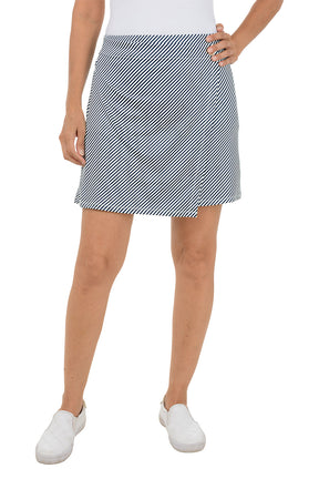 Person wearing a striped skirt on a white background.