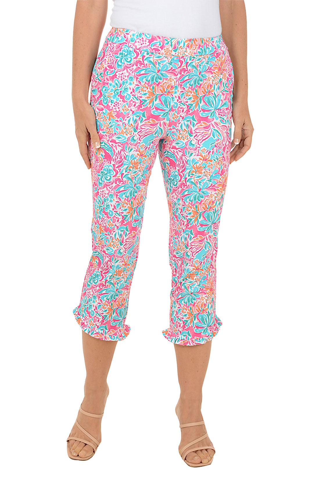Colorful floral capri pants worn by a person on a white background