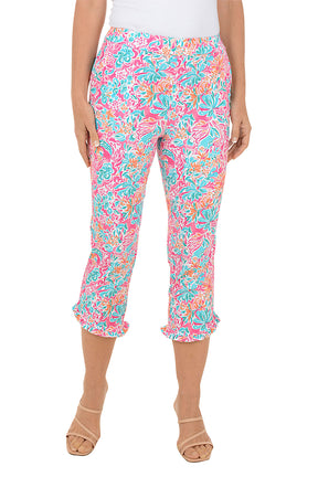 Colorful floral capri pants worn by a person on a white background