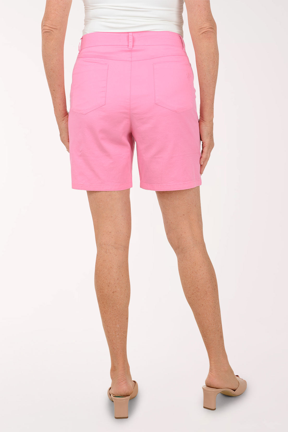 Person wearing pink shorts on a white background