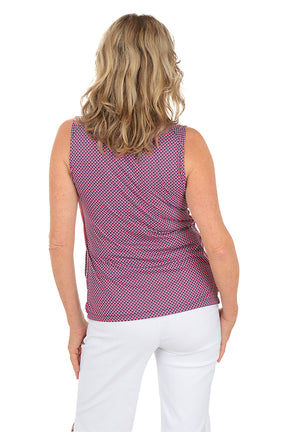 A woman wearing a sleeveless polo top in a pink multi color. Back shot.