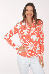 Woman wearing a red and white floral blouse on a white background