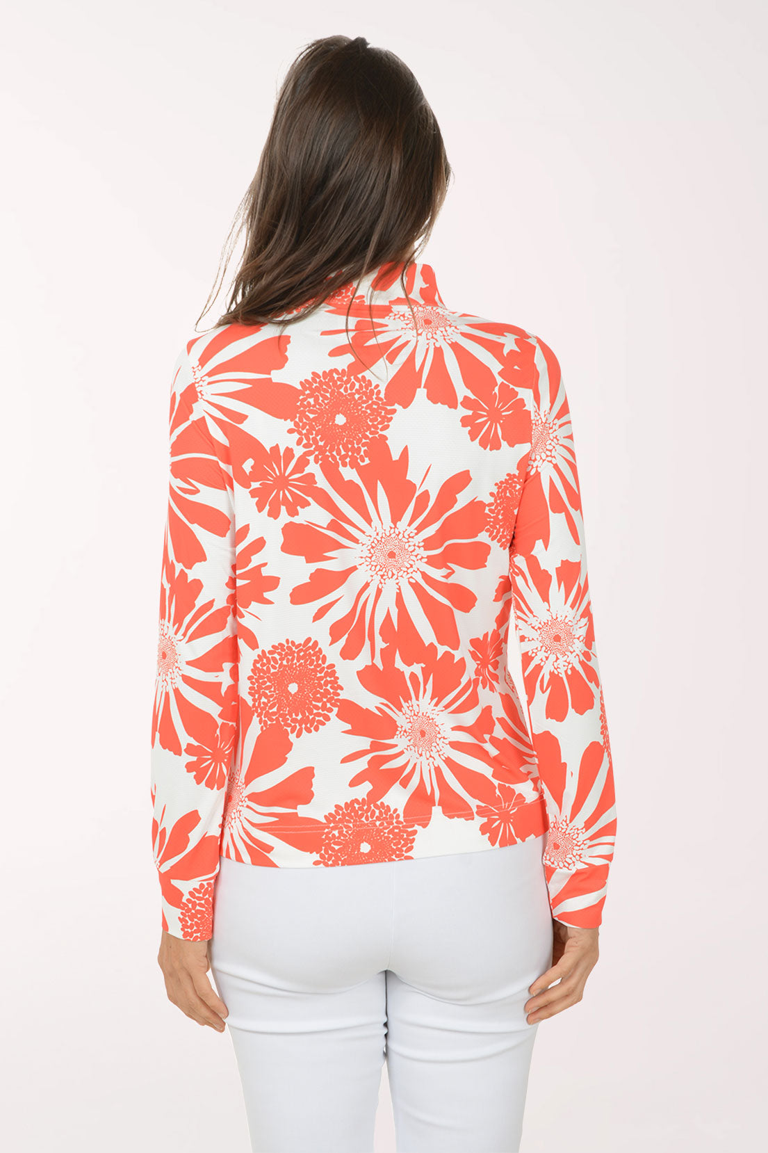 Woman wearing a red and white floral blouse on a white background