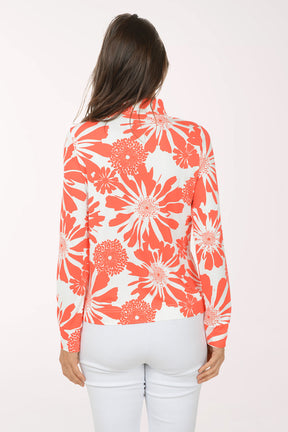 Woman wearing a red and white floral blouse on a white background