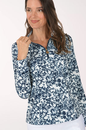 Woman wearing a blue floral patterned shirt on a white background
