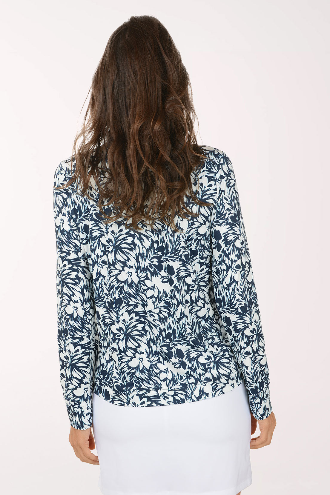 Woman wearing a blue floral patterned shirt on a white background