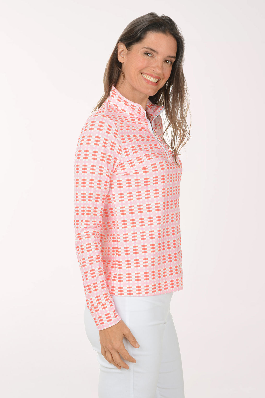 Woman wearing a pink patterned long-sleeve shirt on a white background
