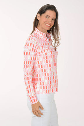 Woman wearing a pink patterned long-sleeve shirt on a white background