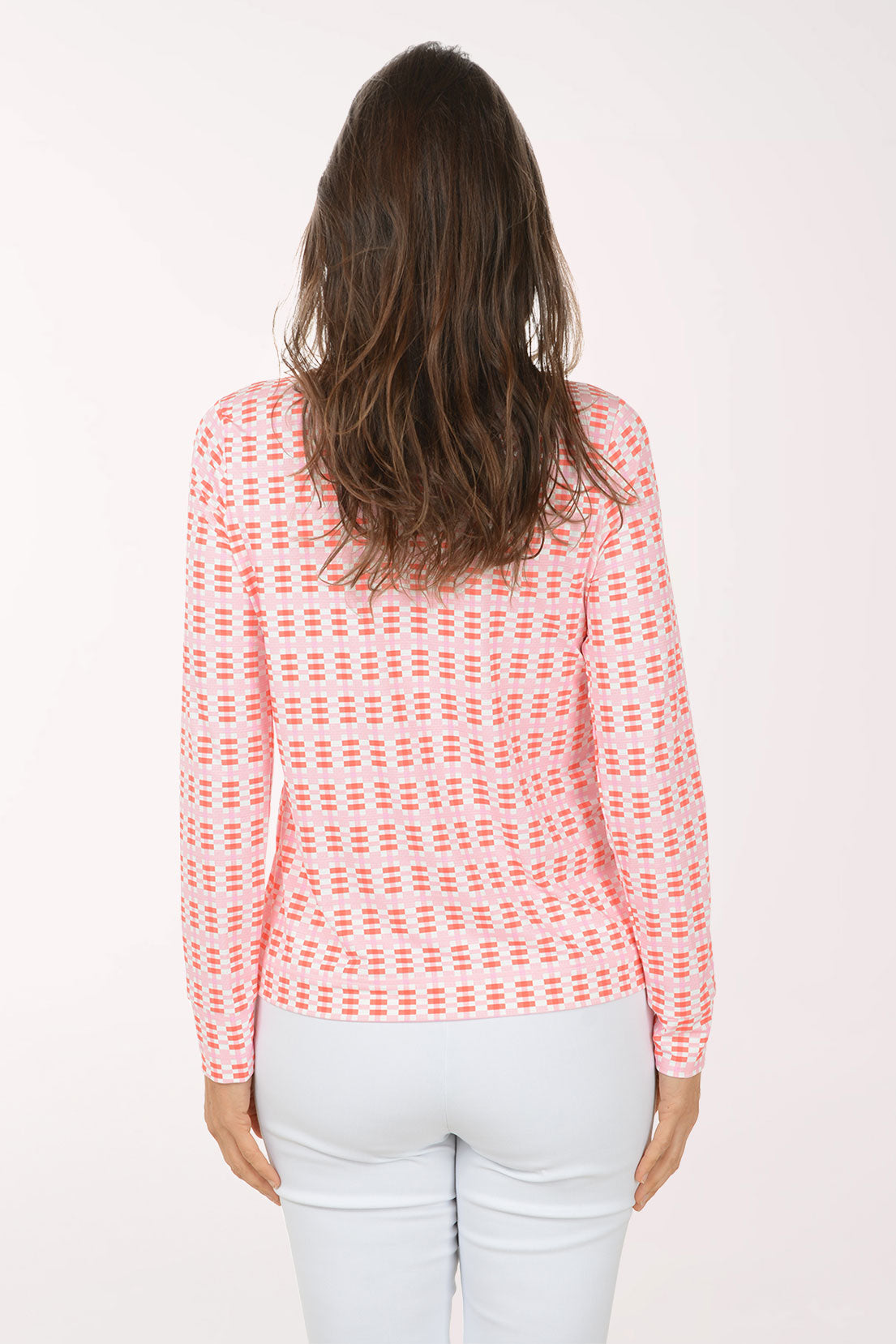 Woman wearing a pink patterned long-sleeve shirt on a white background