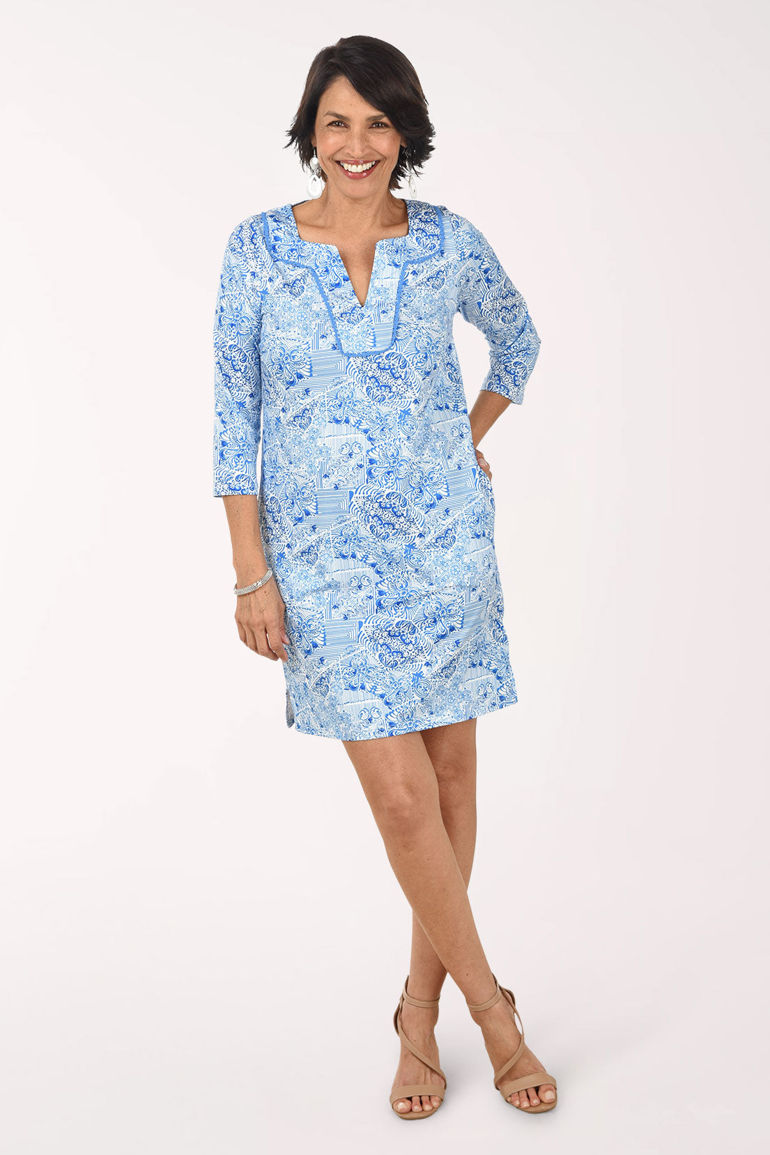 Woman wearing a light blue floral dress on a white background