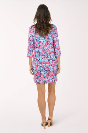 Woman wearing a colorful floral dress on a white background