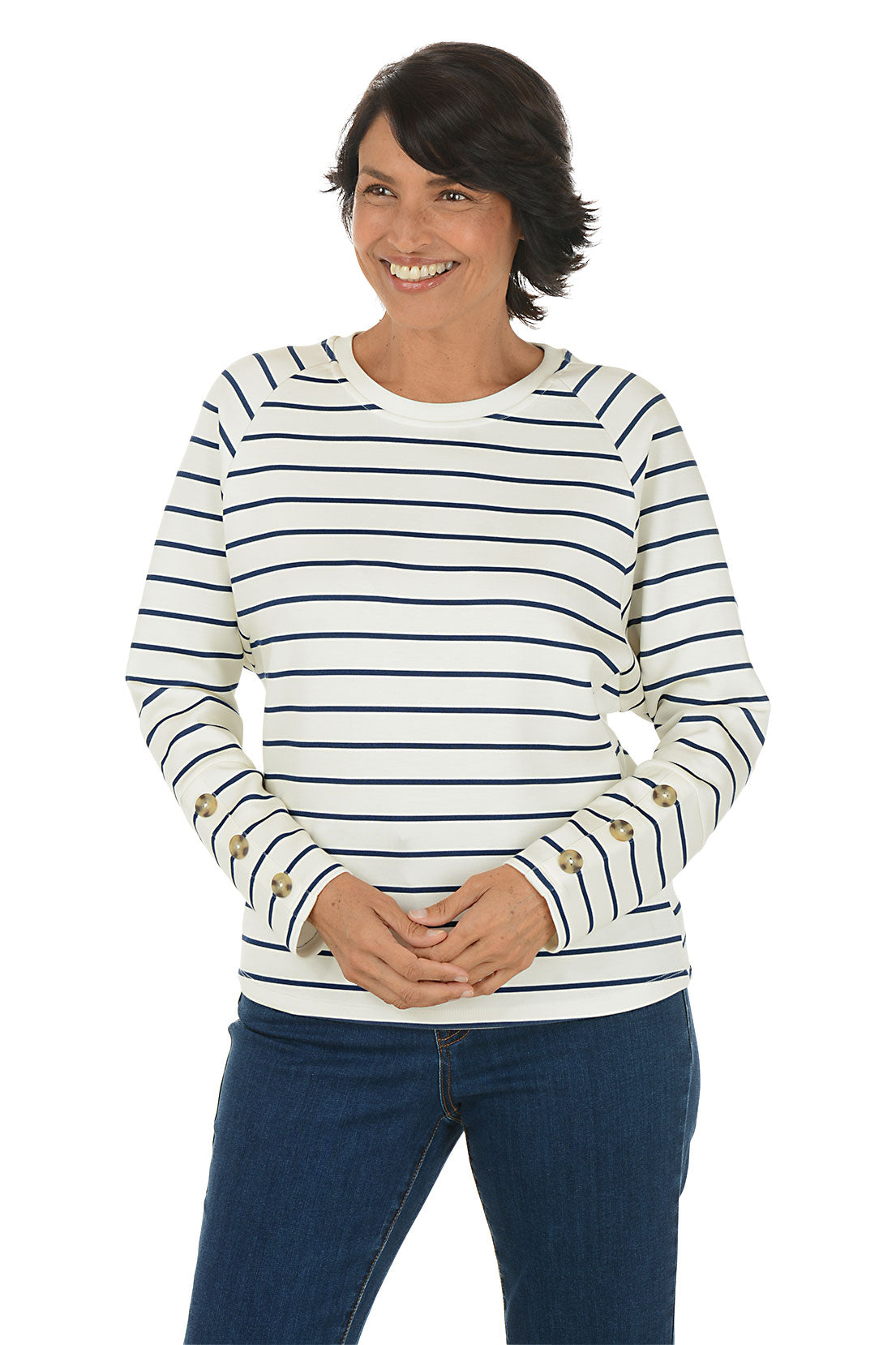 Woman wearing a white and navy striped crew neck sweater.