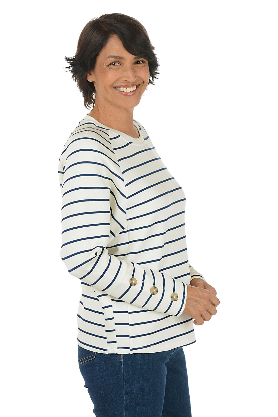 Woman wearing a white and navy striped crew neck sweater. Side shot.