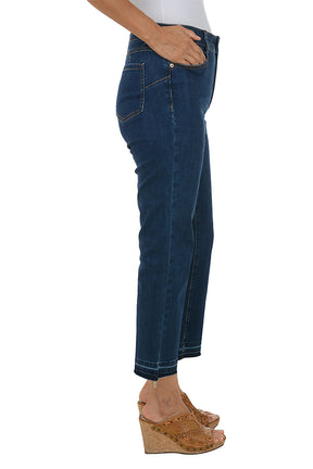 Person wearing dark blue jeans on a white background. Side shot.