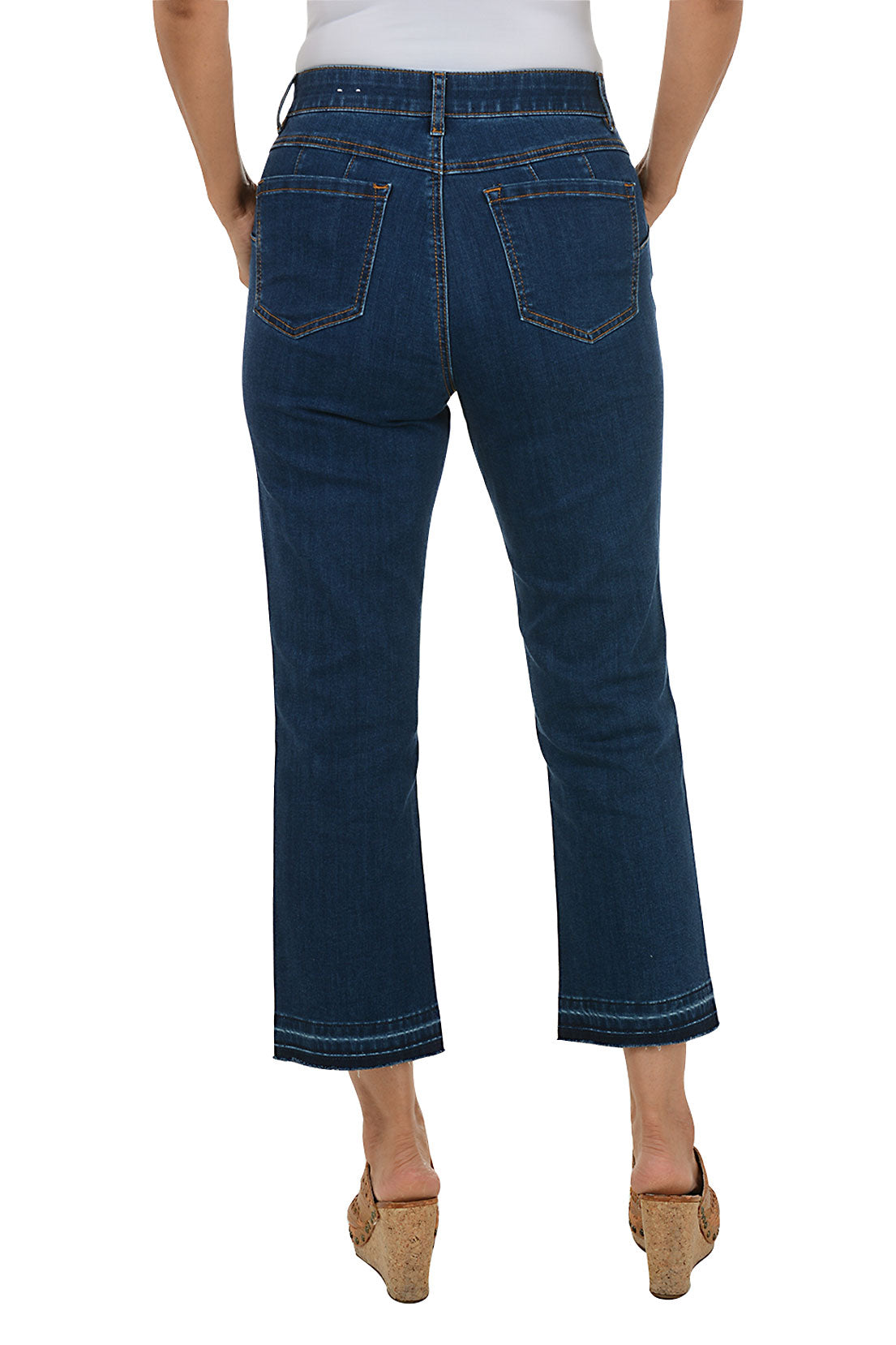 Person wearing dark blue jeans on a white background. Back shot.