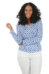 Woman wearing a blue and white checkered shirt on a white background.