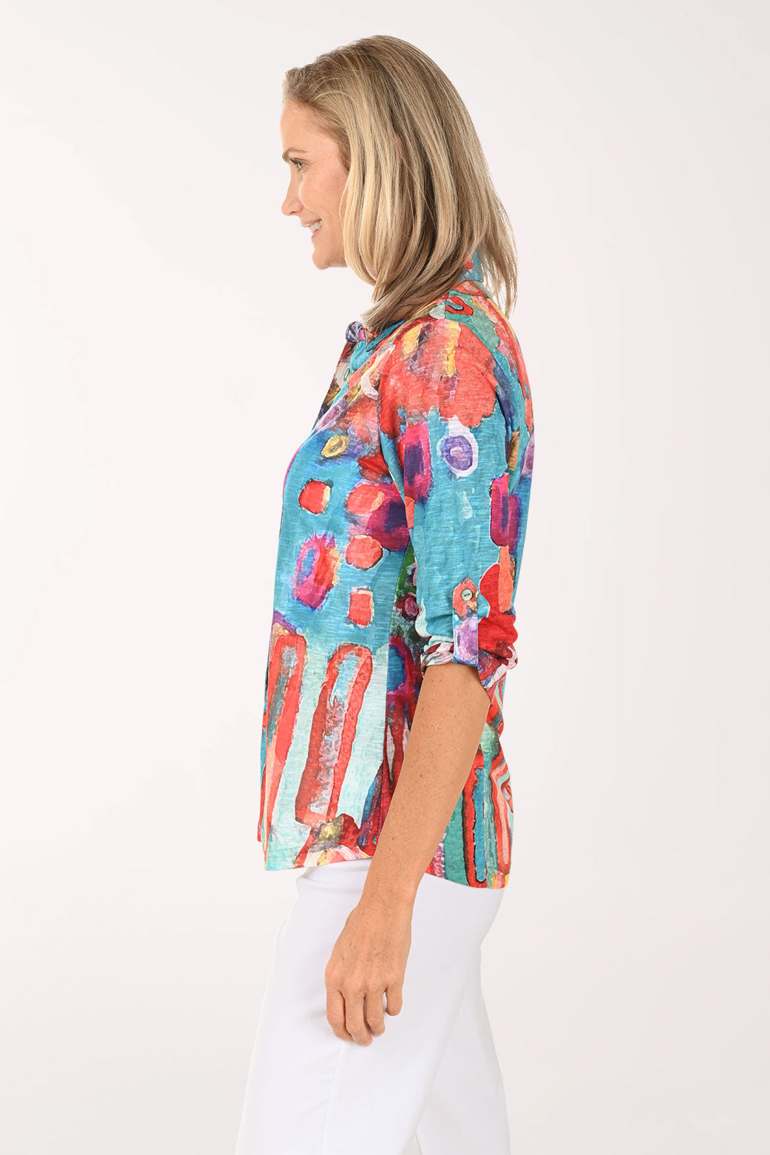 Woman wearing a multi colored button down top