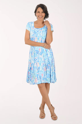 Woman wearing a blue patterned dress on a white background