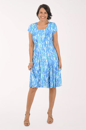 Woman wearing a blue patterned dress on a white background