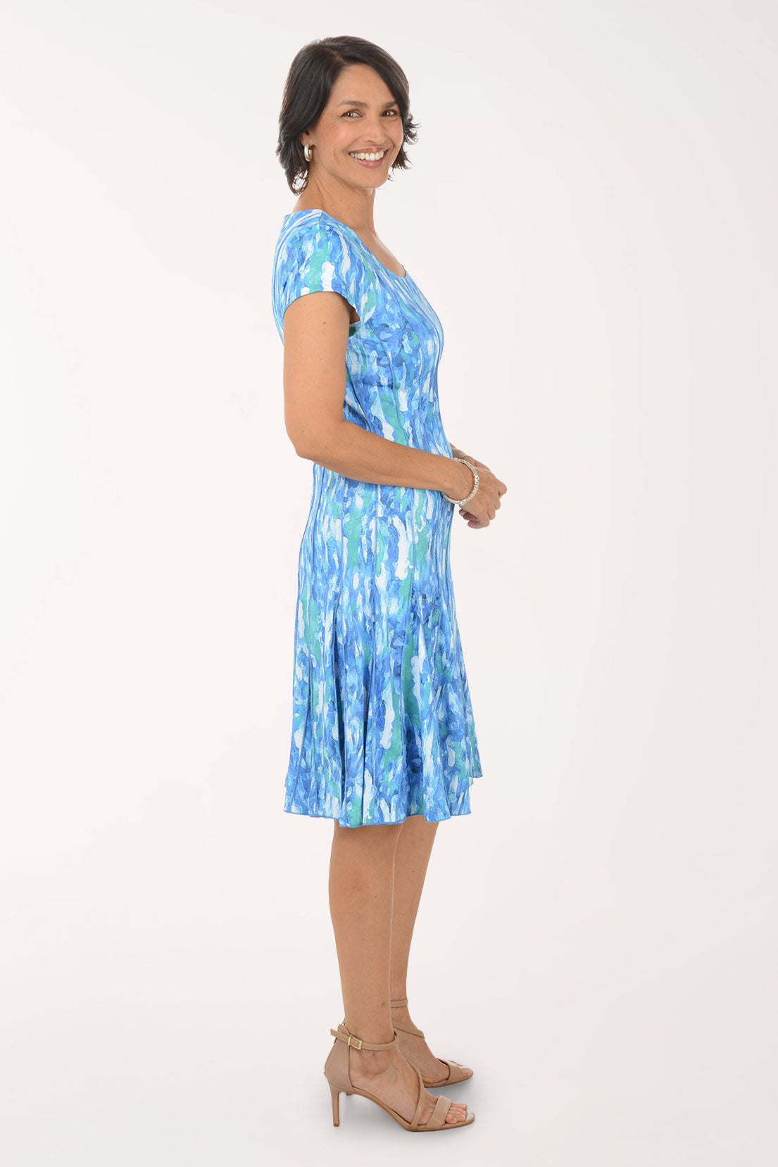 Woman wearing a blue patterned dress on a white background