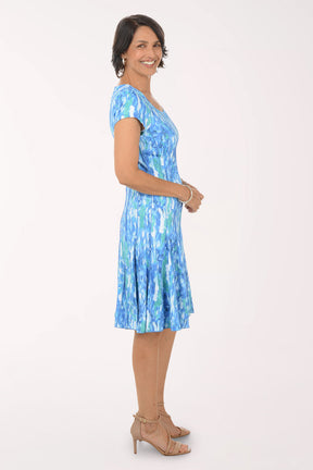 Woman wearing a blue patterned dress on a white background