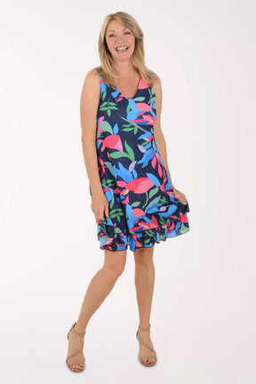 Woman wearing a colorful dress with a floral pattern on a white background