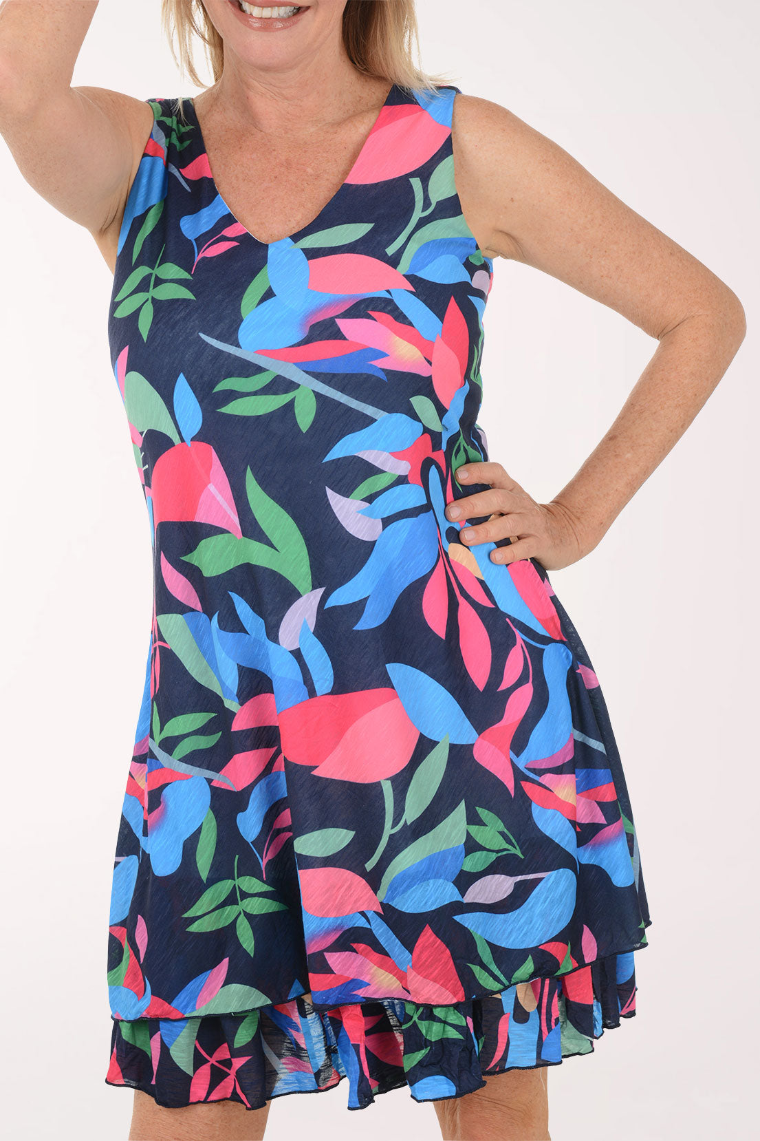 Woman wearing a colorful dress with a floral pattern on a white background