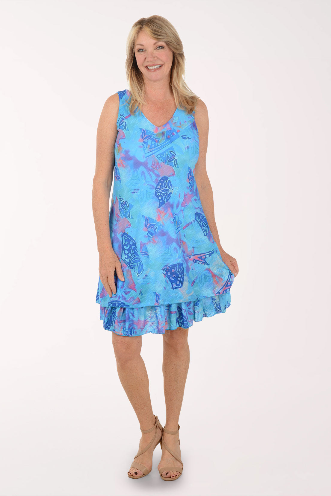Woman wearing a blue patterned dress on a white background