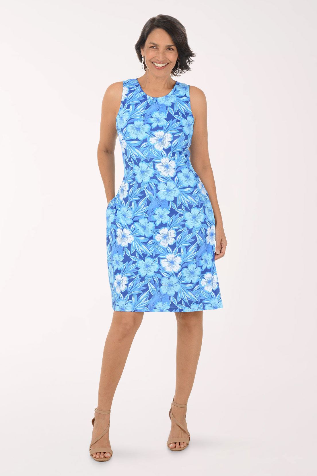 Woman wearing a blue floral dress on a white background