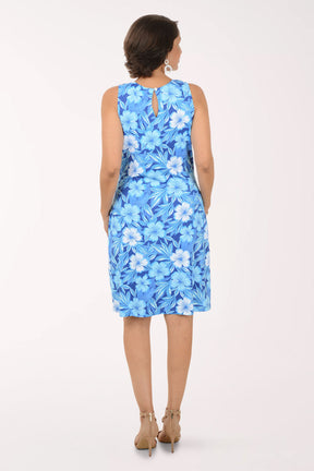 Woman wearing a blue floral dress on a white background