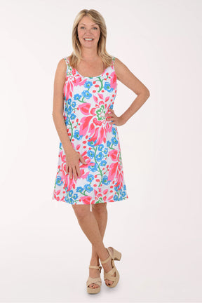 Woman wearing a colorful floral dress on a white background