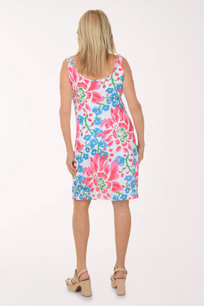 Woman wearing a colorful floral dress on a white background