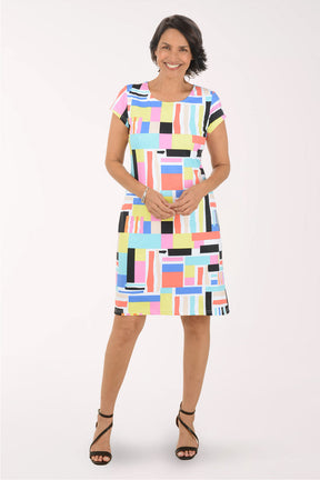 Woman wearing a colorful geometric patterned dress on a white background