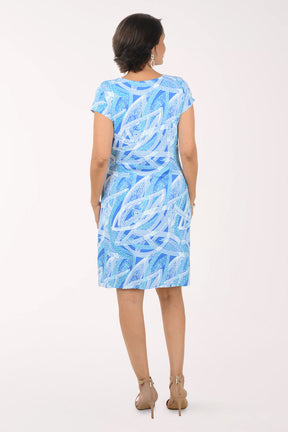 Woman wearing a blue patterned dress on a white background