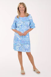Woman wearing a blue patterned dress on a white background