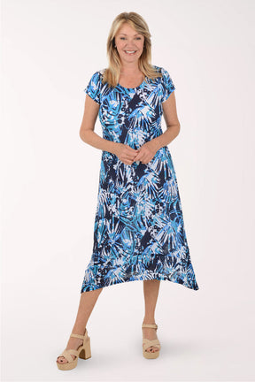 Woman wearing a blue floral dress on a white background