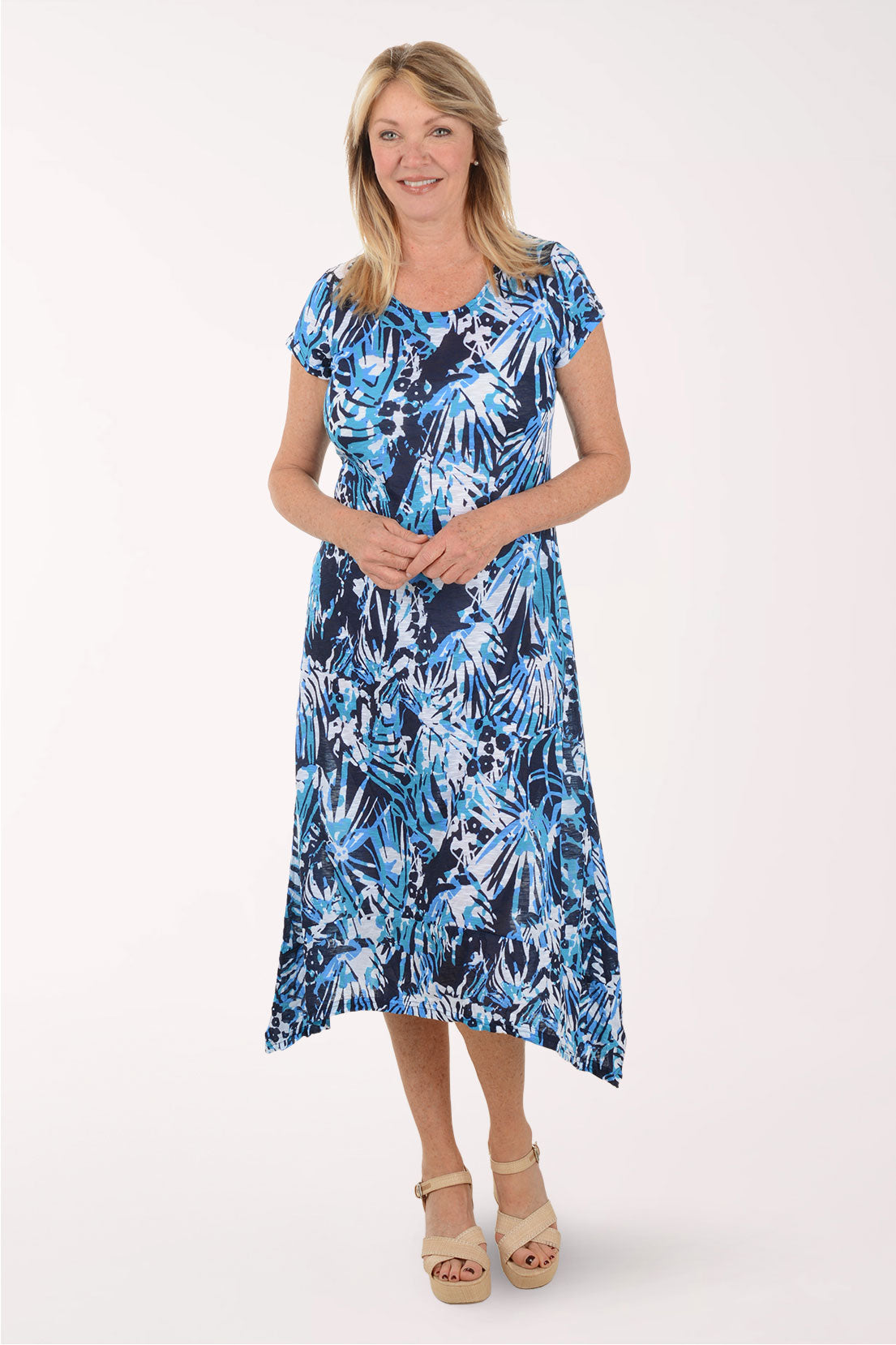 Woman wearing a blue floral dress on a white background