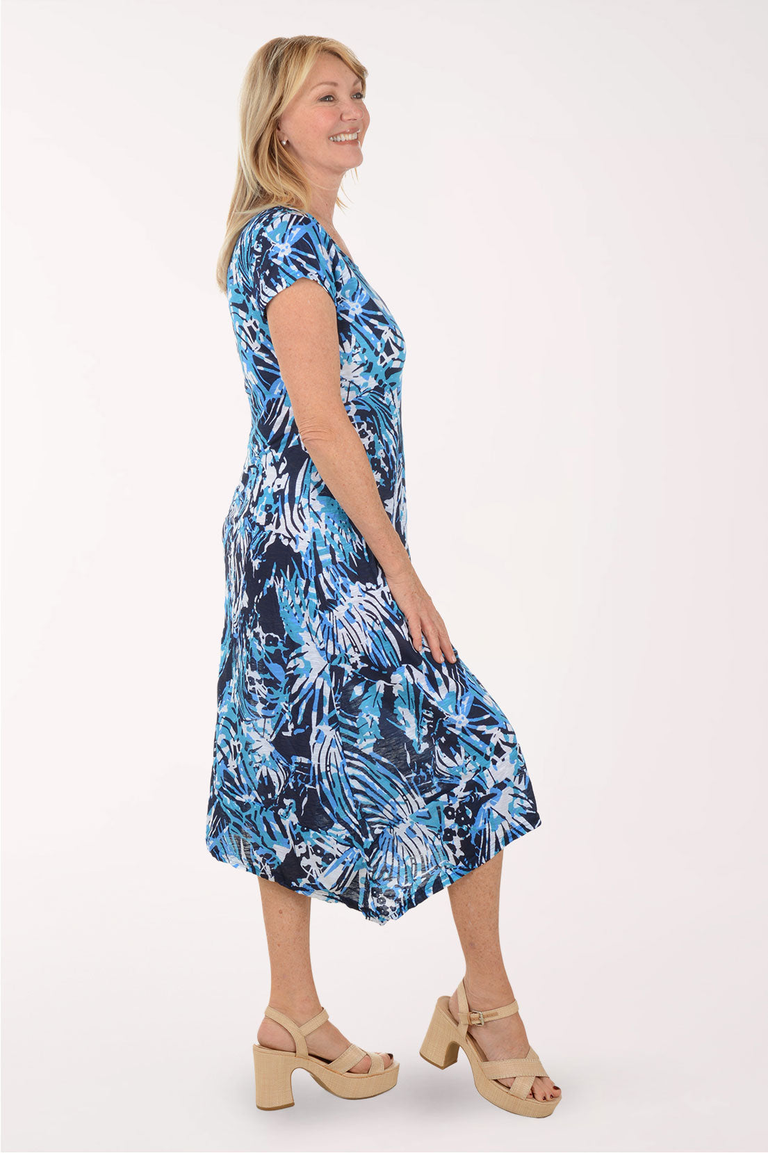 Woman wearing a blue floral dress on a white background