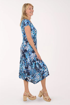 Woman wearing a blue floral dress on a white background
