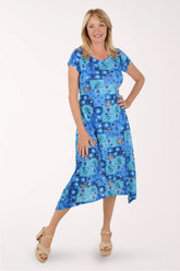 Woman wearing a blue patterned dress on a white background