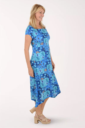 Woman wearing a blue patterned dress on a white background