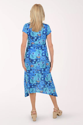 Woman wearing a blue patterned dress on a white background