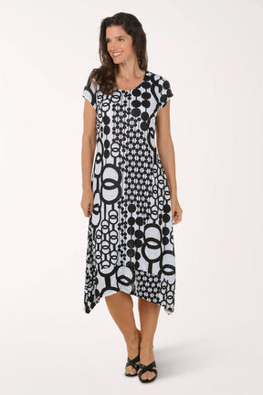 Woman wearing a black and white patterned midi dress on a white background