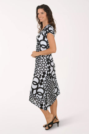 Woman wearing a black and white patterned midi dress on a white background