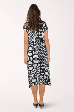 Woman wearing a black and white patterned midi dress on a white background