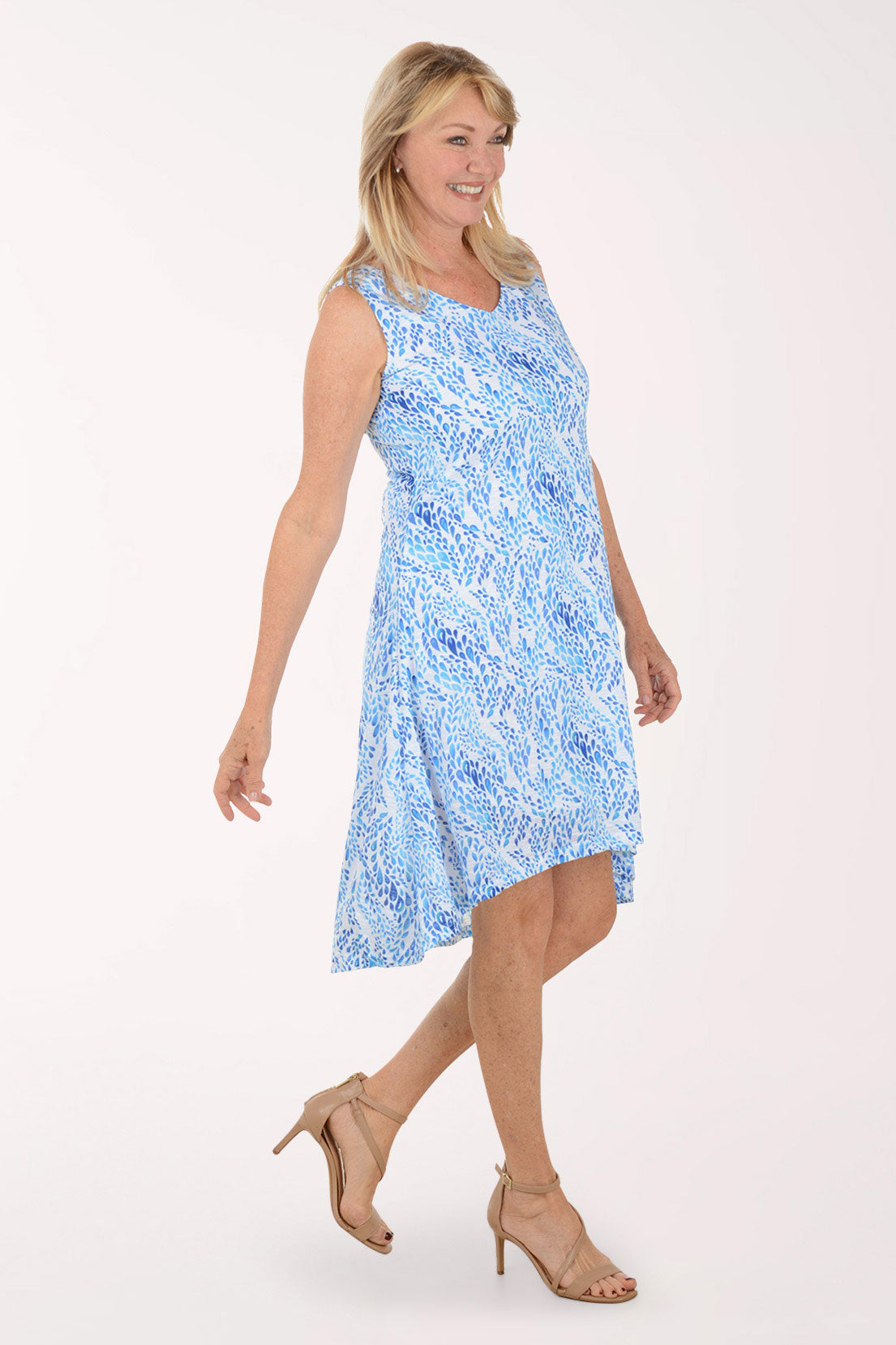 Woman wearing a blue floral dress on a white background