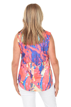 Woman wearing a colorful sleeveless top with a white background. Back shot.